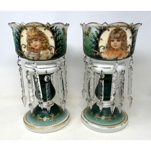 554 - A pair of glass lustres with prismatic drops, decorated children, 30 cm high (2)