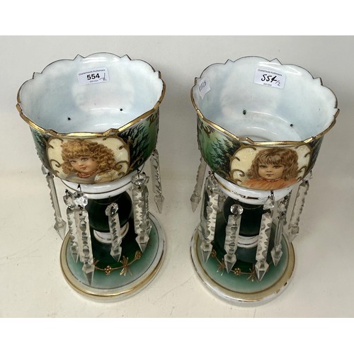 554 - A pair of glass lustres with prismatic drops, decorated children, 30 cm high (2)