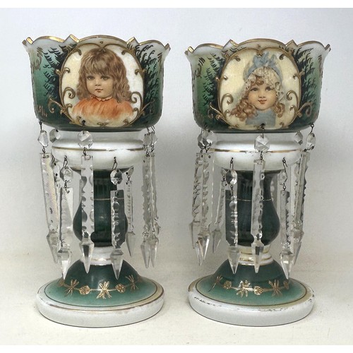 554 - A pair of glass lustres with prismatic drops, decorated children, 30 cm high (2)