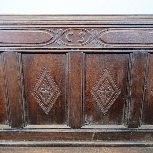 666 - A 17th century style carved oak settle, with a painted leather panel to the seat and arms, 130 cm wi... 