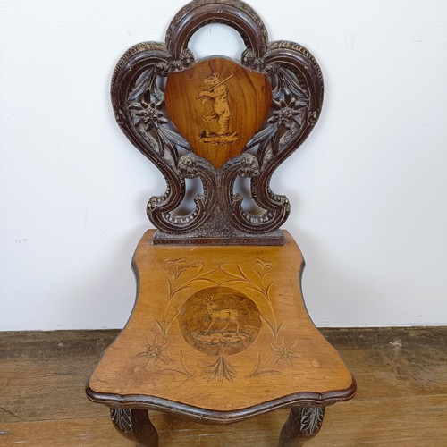 668 - An unusual Swiss/Austrian marquetry inlaid and carved wood child's musical chair, decorated a bear a... 