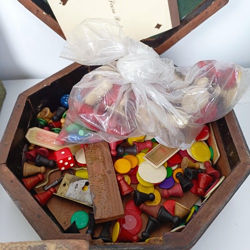 616 - A chessboard, in the form of a book, a mahogany box, assorted playing cards and game tokens (box)