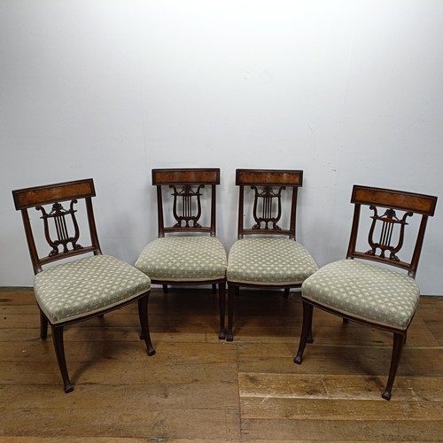 669 - A set of four mahogany dining chairs, with carved lyre backs (4)