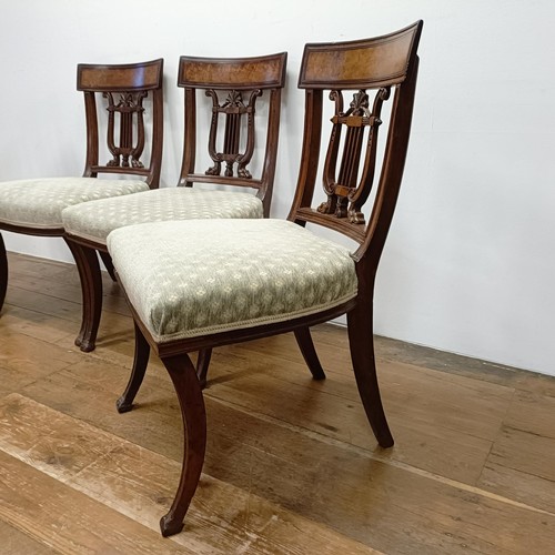 669 - A set of four mahogany dining chairs, with carved lyre backs (4)