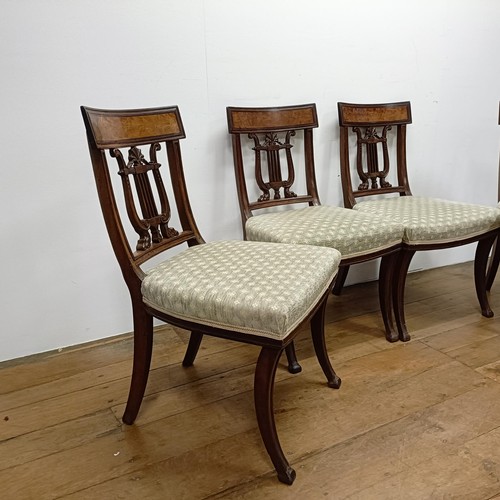 669 - A set of four mahogany dining chairs, with carved lyre backs (4)