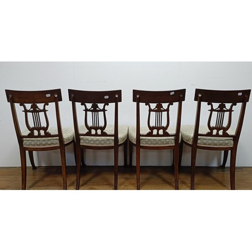 669 - A set of four mahogany dining chairs, with carved lyre backs (4)