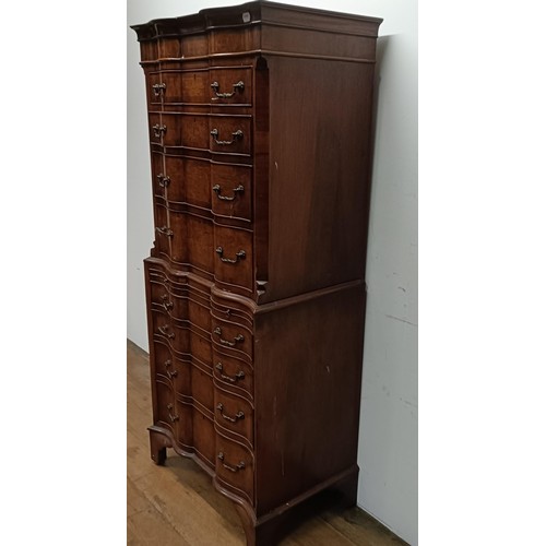 715 - An 18th century style walnut tallboy, of shaped form, the top having four graduated drawers, on a ba... 