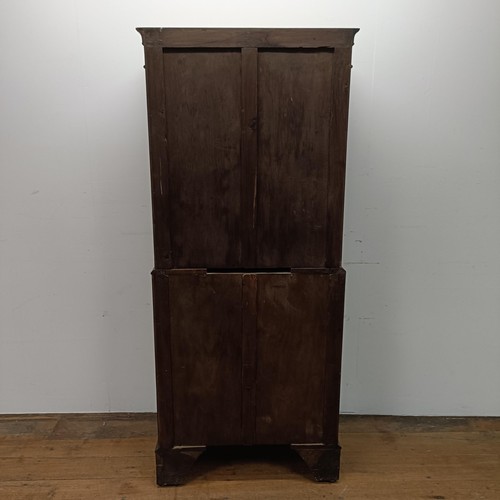 715 - An 18th century style walnut tallboy, of shaped form, the top having four graduated drawers, on a ba... 