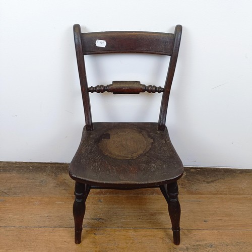 717 - A 19th century child's elm kitchen style chair