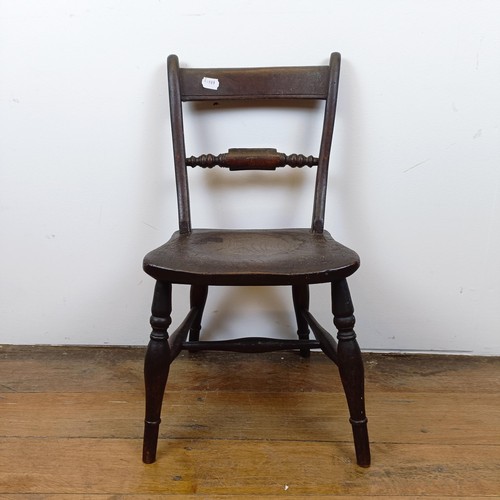 717 - A 19th century child's elm kitchen style chair