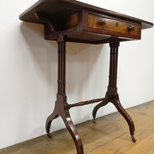 718 - A 19th century mahogany work table, on twin end supports united by a stretcher, 46 cm wide