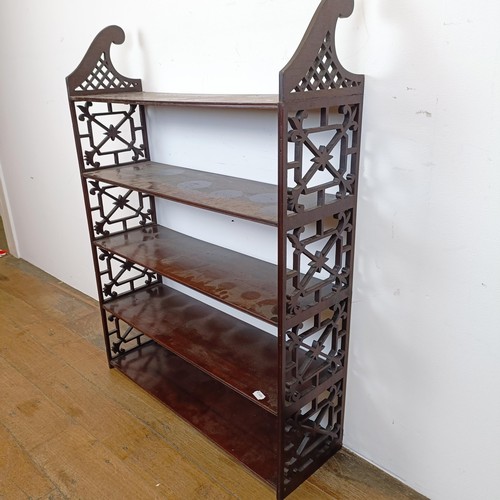 720 - A set of mahogany wall shelves, with fret carved ends, in the Chippendale manner, 105 cm high