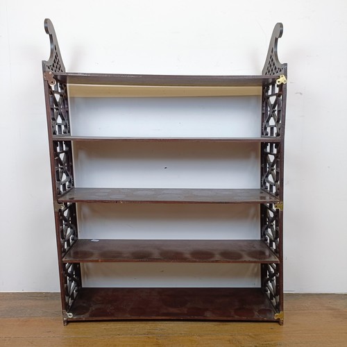 720 - A set of mahogany wall shelves, with fret carved ends, in the Chippendale manner, 105 cm high