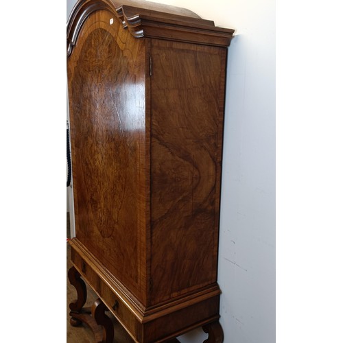 723 - An 18th century style walnut cabinet on stand, the top with two doors revealling a fitted interior w... 