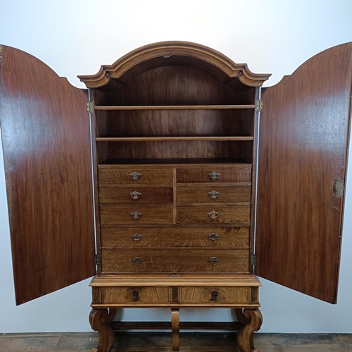 723 - An 18th century style walnut cabinet on stand, the top with two doors revealling a fitted interior w... 