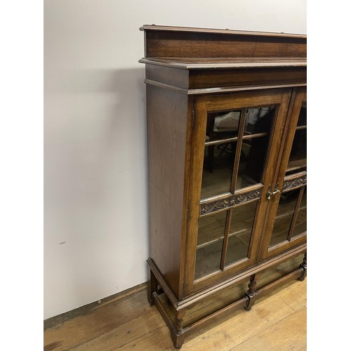 726 - An oak bookcase, with three glazed doors, 154 cm wide