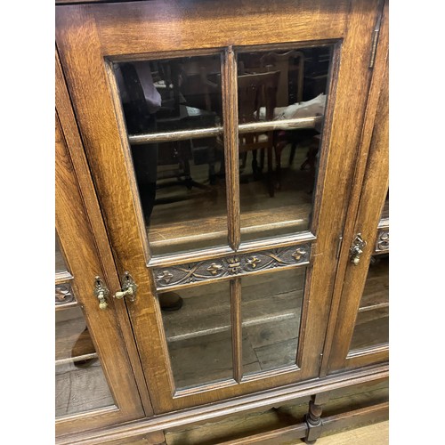 726 - An oak bookcase, with three glazed doors, 154 cm wide