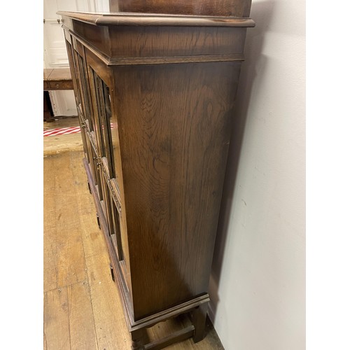 726 - An oak bookcase, with three glazed doors, 154 cm wide