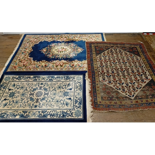 734 - A Persian type rug, 175 x 135 cm, a Chinese rug, 160 x 92 cm, and a Chinese carpet, 215 x 140 (3)