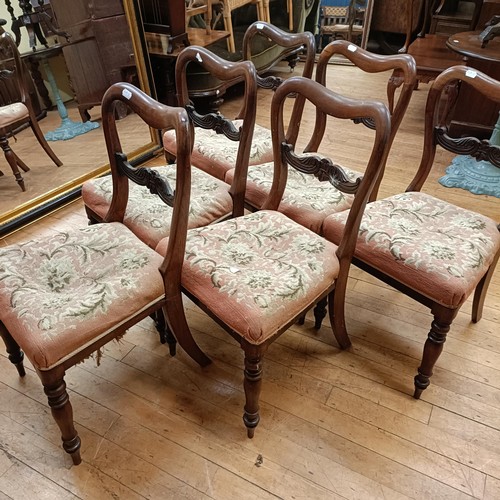 753 - A set of six mahogany balloon back dining chairs, with upholstered seats, on turned legs