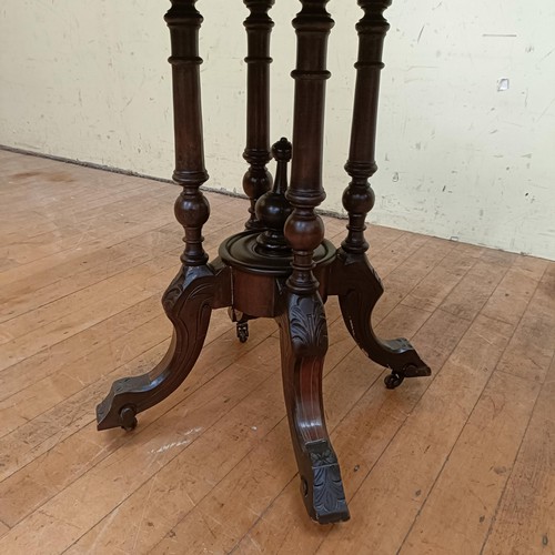 758 - A walnut lamp table, with an octagonal top, 72 cm wide