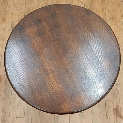 760 - A table, with a stained top, on a painted cast metal base, 75 cm diameter