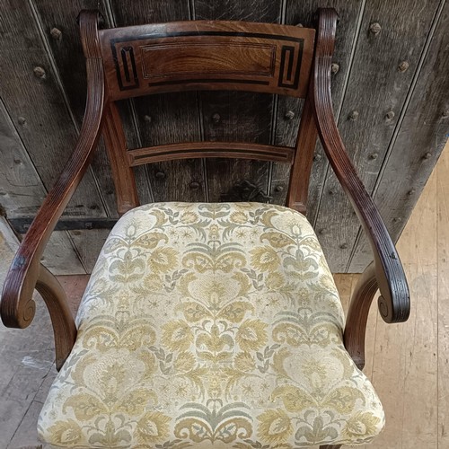 765 - A mahogany bar back armchair, with a padded seat, on sabre legs