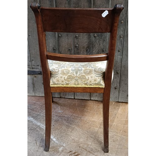 765 - A mahogany bar back armchair, with a padded seat, on sabre legs