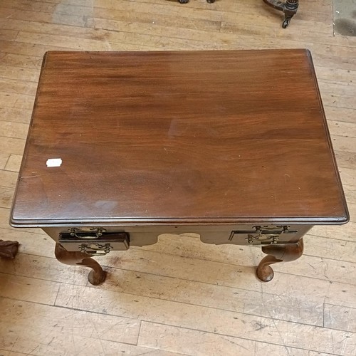 768 - A mahogany lowboy, with three drawers, on cabriole legs to pad feet, 69 cm wide