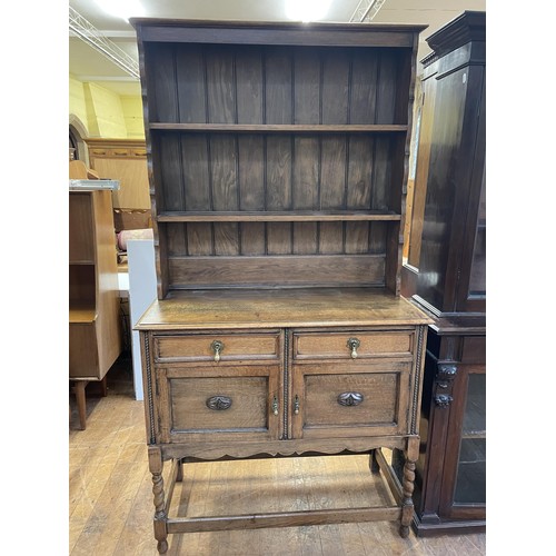 794 - A pine cupboard, 90 cm wide, a pine wine table, two wine racks, assorted pictures, an oak dresser, a... 