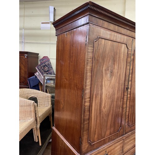 759 - A 19th century mahogany linen press, the top with two cupboard doors, to reveal slides, on a base wi... 