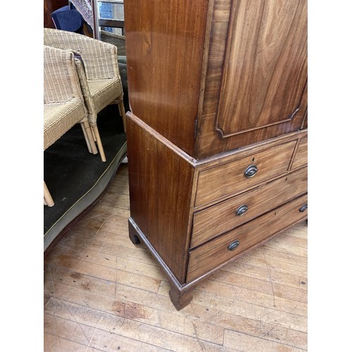 759 - A 19th century mahogany linen press, the top with two cupboard doors, to reveal slides, on a base wi... 