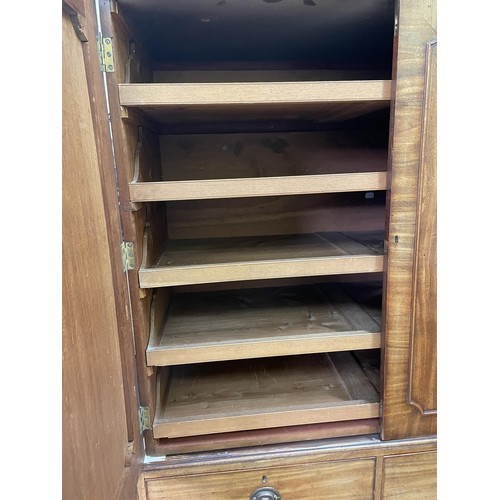 759 - A 19th century mahogany linen press, the top with two cupboard doors, to reveal slides, on a base wi... 