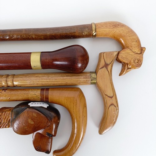 587 - A walking stick, the handle carved in the form of a dog, 38 cm, and four other walking sticks (5)