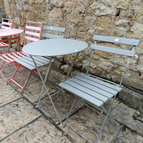 813 - A green garden folding table with matching chairs, and another garden folding table with matching ch... 