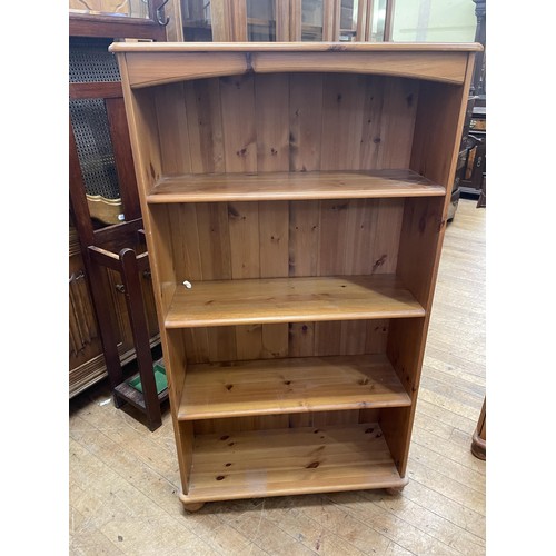 783 - A pine bookcase, 93 cm wide, a pine chest, a hi-fi unit, a walnut bedside chest, three pine bedside ... 