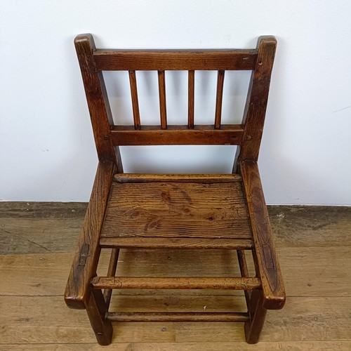 639 - A child's primitive elm chair