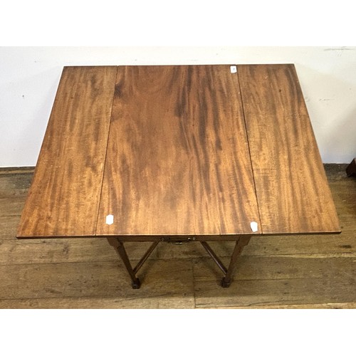 750 - A George III mahogany Pembroke table, on square chamfered legs, united by an X frame, 76 cm wide