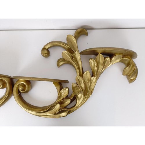 653 - A pair of gesso wall brackets,of scroll form, 57 cm wide (2)