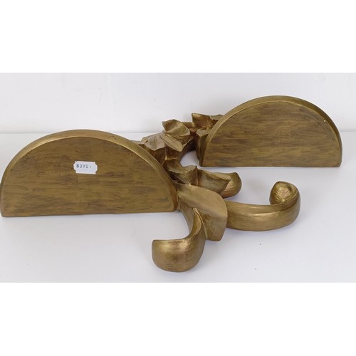 653 - A pair of gesso wall brackets,of scroll form, 57 cm wide (2)