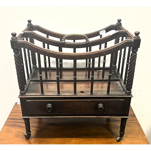 690 - A 19th century mahogany Canterbury, with a brass handle,  the base with a drawer, on turned legs to ... 