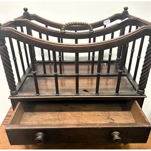 690 - A 19th century mahogany Canterbury, with a brass handle,  the base with a drawer, on turned legs to ... 