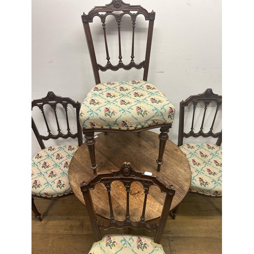 645 - A set of four 19th century walnut dining chairs, and an oak wine table, 78 cm diameter (5)