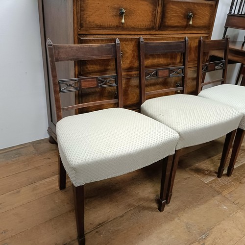 661 - An oak chest, 107 cm wide, three dining chairs and a convex wall mirror, 70 cm diameter, a mahogany ... 