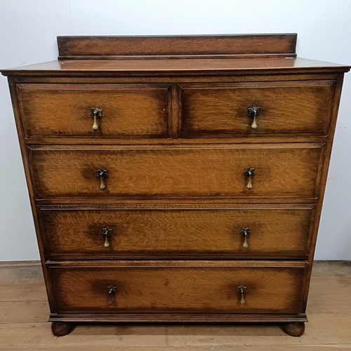 661 - An oak chest, 107 cm wide, three dining chairs and a convex wall mirror, 70 cm diameter, a mahogany ... 