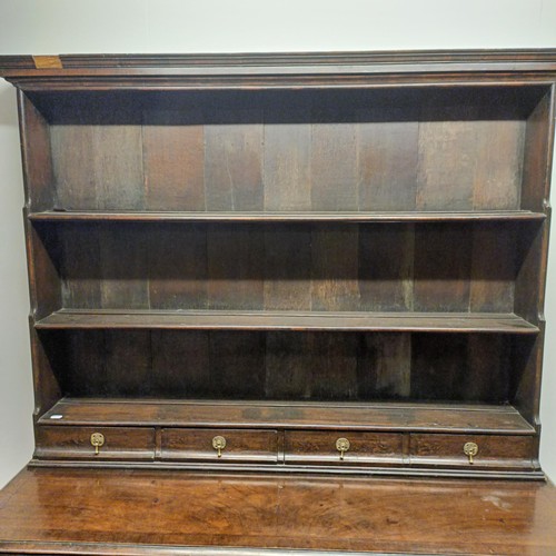 728 - An 18th century style dresser, veneered in walnut, having a three tier plate rack, on a base with th... 