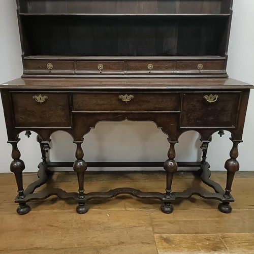 728 - An 18th century style dresser, veneered in walnut, having a three tier plate rack, on a base with th... 