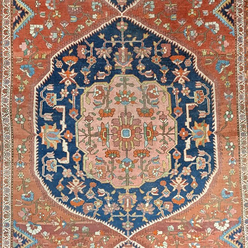 627 - A Tribal red ground rug, 230 x 160 cm