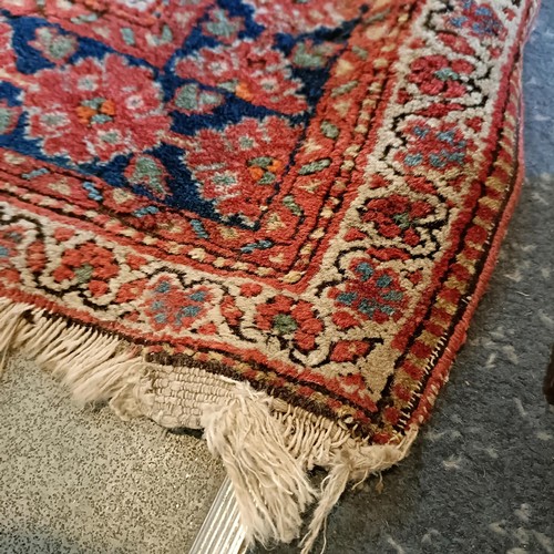 627 - A Tribal red ground rug, 230 x 160 cm