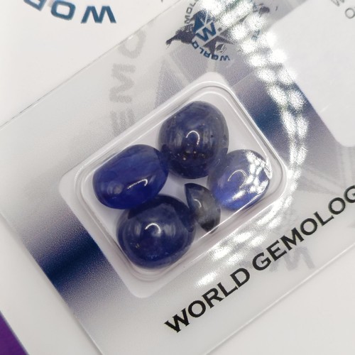 17 - A certificated parcel of five security-sealed cabochon sapphire and glass composite gemstones, 25.69... 